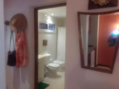 a bathroom with a toilet and a mirror at Paraiso Serrano in La Población