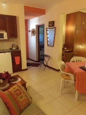 a kitchen and a living room with a table and chairs at Paraiso Serrano in La Población