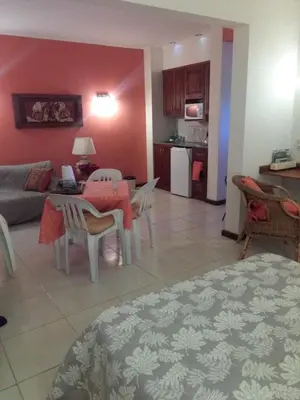 a living room with a couch and a table and a kitchen at Paraiso Serrano in La Población