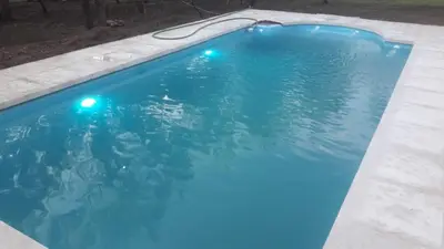 a blue swimming pool with lights in it at Paraiso Serrano in La Población