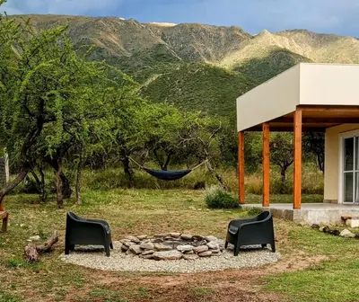 a hammock hanging over a fire pit in a yard at Casa de montaña in Cortaderas