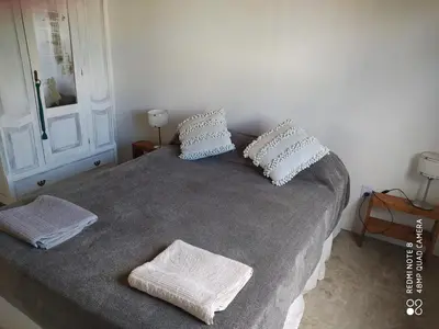 a bedroom with a bed with two pillows on it at Casa de montaña in Cortaderas