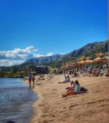a group of people sitting on a beach at Casa de montaña in Cortaderas