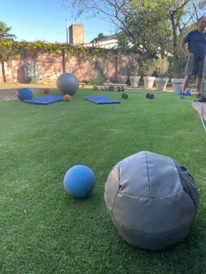 a boy standing in a yard with balls on the grass at Loft terraza del norte a mts de sanatorio Allende, Hospital Privado y estadio Kempes in Cordoba