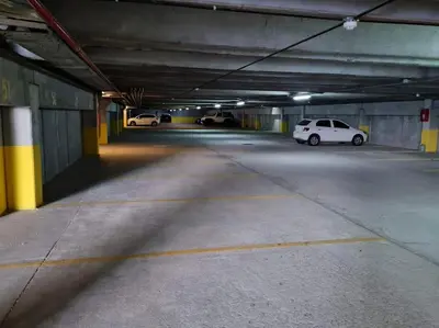 an empty parking garage with cars parked in it at Medilan Kempes Exclusivo in Cordoba
