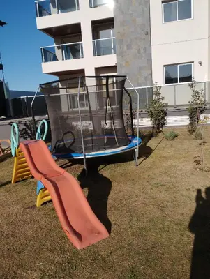 a playground with a trampoline and a slide at Medilan Kempes Exclusivo in Cordoba