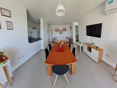 a dining room and living room with a table and chairs at Medilan Kempes Exclusivo in Cordoba