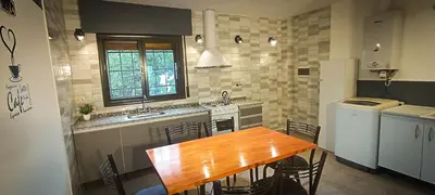 a kitchen with a wooden table in a kitchen at Departamento HOSPITAL PRIVADO - QUALITY - 