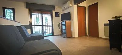 a living room with a couch and two windows at Departamento HOSPITAL PRIVADO - QUALITY - 