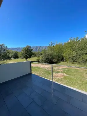 a balcony with a view of a field at DelViento Cabañas in Las Rabonas