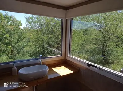 a bathroom with a sink and a large window at DelViento Cabañas in Las Rabonas