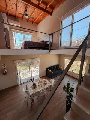 a living room with a couch and a table at DelViento Cabañas in Las Rabonas