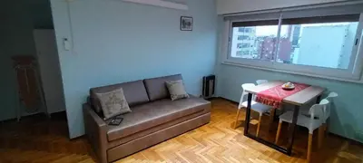a living room with a couch and a table at Departamento temporario pateto in Cordoba