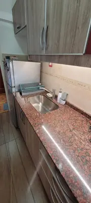 a kitchen with a sink and a counter top at Departamento temporario pateto in Cordoba