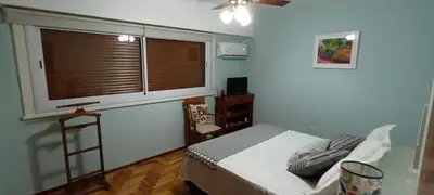 a bedroom with a bed and a large window at Departamento temporario pateto in Cordoba