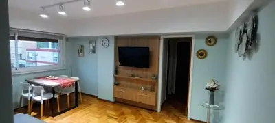 a living room with a table and a television at Departamento temporario pateto in Cordoba