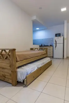 a room with two bunk beds and a refrigerator at Depto con excelente ubicación by Lofty in Cordoba