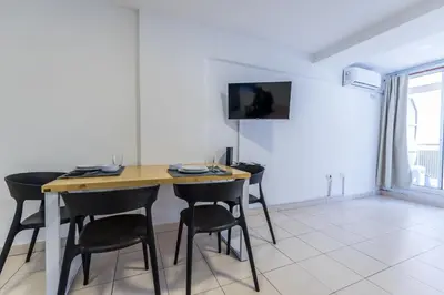a dining room with a wooden table and chairs at Depto con excelente ubicación by Lofty in Cordoba