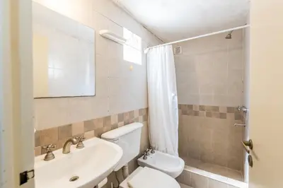 a bathroom with a toilet and a sink at Depto con excelente ubicación by Lofty in Cordoba