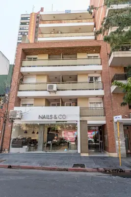 a building with a nalls and co sign on it at Depto con excelente ubicación by Lofty in Cordoba