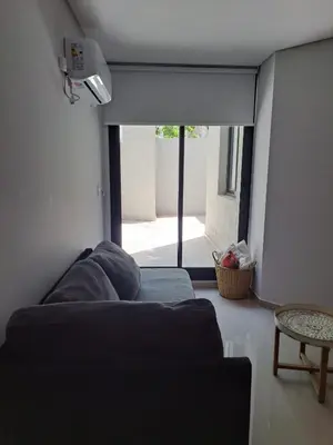a living room with a couch and a large window at DPTO Catedralle Alta Cordoba PB in Cordoba