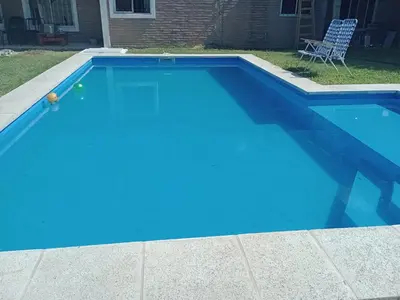 a blue swimming pool in a yard at Fenix in Alto de la Piedra