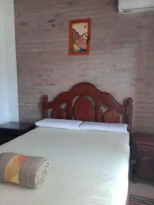 a bed with a wooden head board in a bedroom at Fenix in Alto de la Piedra