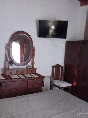 a bedroom with a dresser and a mirror on the wall at Fenix in Alto de la Piedra