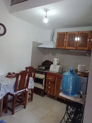 a kitchen with a stove and a table with chairs at Fenix in Alto de la Piedra
