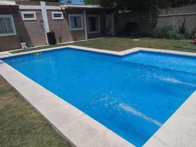 a swimming pool with blue water in a yard at Fenix in Alto de la Piedra