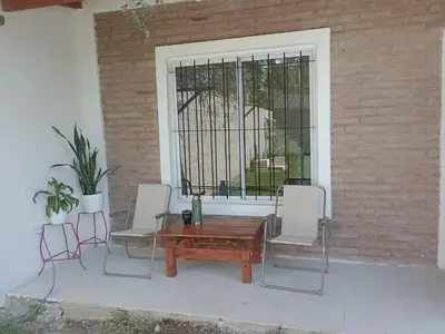 a patio with a table and chairs and a window at Fenix in Alto de la Piedra