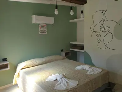 a bedroom with a bed with towels on it at Sierras Alojamiento SUITE in Mina Clavero