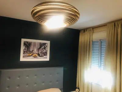 a bedroom with a bed and a ceiling light at NUEVOCENTRO 1 in Cordoba