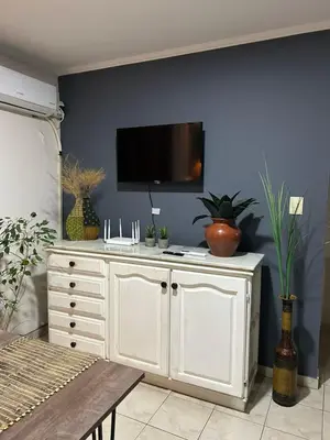 a white cabinet with a tv on a blue wall at NUEVOCENTRO 1 in Cordoba