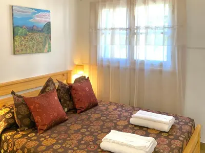 a bedroom with a bed with two towels on it at B&B Mina Clavero in Mina Clavero