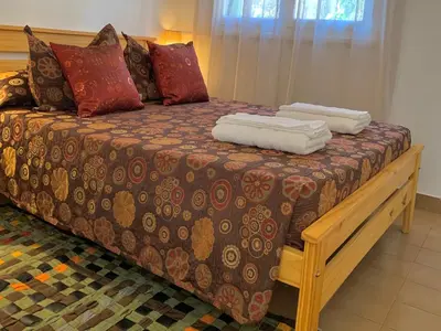 a bed with two towels on top of it at B&B Mina Clavero in Mina Clavero