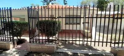 a iron fence with a plant behind it at Monoambiente Anisacate in Villa Anizacate