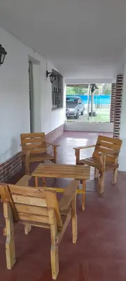a group of wooden benches in a room with a window at Monoambiente Anisacate in Villa Anizacate