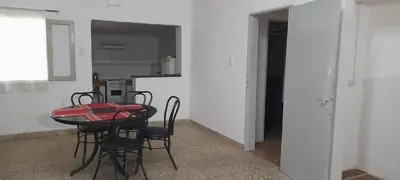 a kitchen with a table and chairs in a room at Monoambiente Anisacate in Villa Anizacate