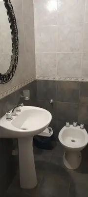 a bathroom with a white sink and a toilet at Monoambiente Anisacate in Villa Anizacate