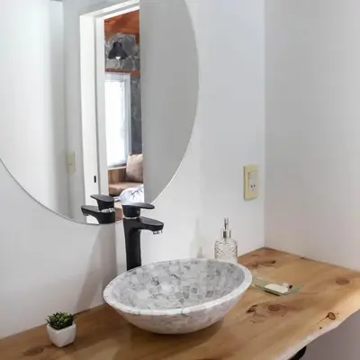 a bathroom with a large stone sink on a wooden counter at Bandruidh - Morada serrana - V. Gral. Belgrano in Villa General Belgrano