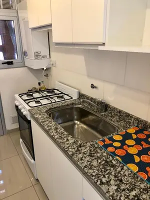 a kitchen with a sink and a stove at ALOHA Güemes Premium, Moderno dpto 1 dorm TORRES H in Cordoba