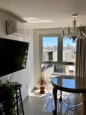 a living room with a table and a large window at ALOHA Güemes Premium, Moderno dpto 1 dorm TORRES H in Cordoba