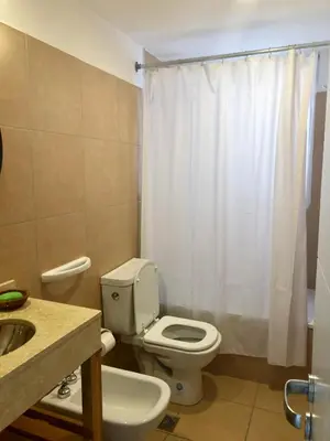 a bathroom with a white toilet and a sink at ALOHA Güemes Premium, Moderno dpto 1 dorm TORRES H in Cordoba