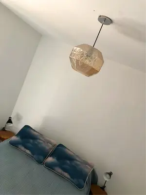 a bedroom with a bed and a pendant light at ALOHA Güemes Premium, Moderno dpto 1 dorm TORRES H in Cordoba