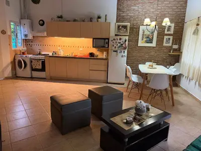 a kitchen with a table and a refrigerator and a table at Villa emma in Villa General Belgrano