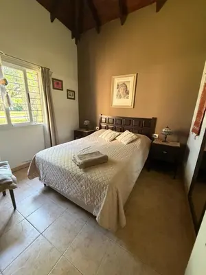 a bedroom with a bed and a window at Villa emma in Villa General Belgrano