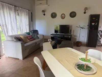a living room with a table and a couch at Villa emma in Villa General Belgrano