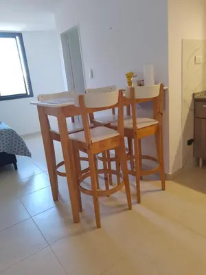 a kitchen with a table and chairs in a room at CiTriPio dpto con Aire acondiconado , wifi y TV in Cordoba