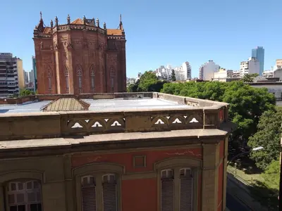 an old building with a clock tower in a city at CiTriPio dpto con Aire acondiconado , wifi y TV in Cordoba